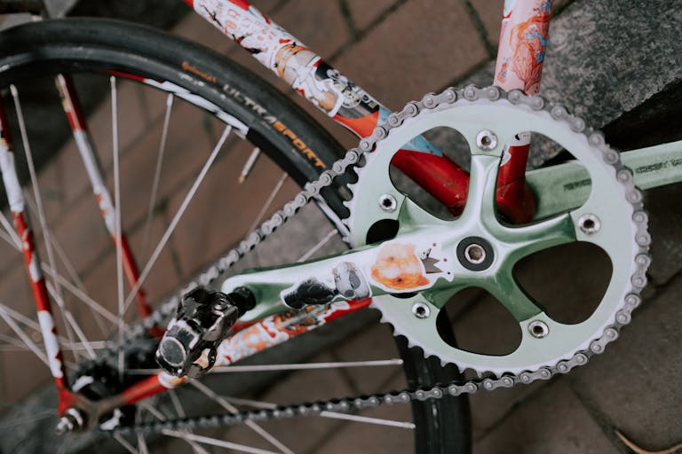 Artistic close-up of a bicycle crankset showcasing vibrant graphics, focusing on the unique design.